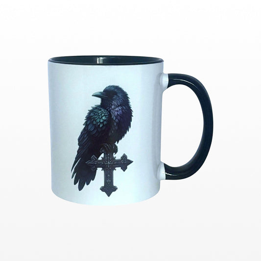 Illustrated Solutions Store gothic mug with a black raven perched on an ornate cross, black handle and rim.