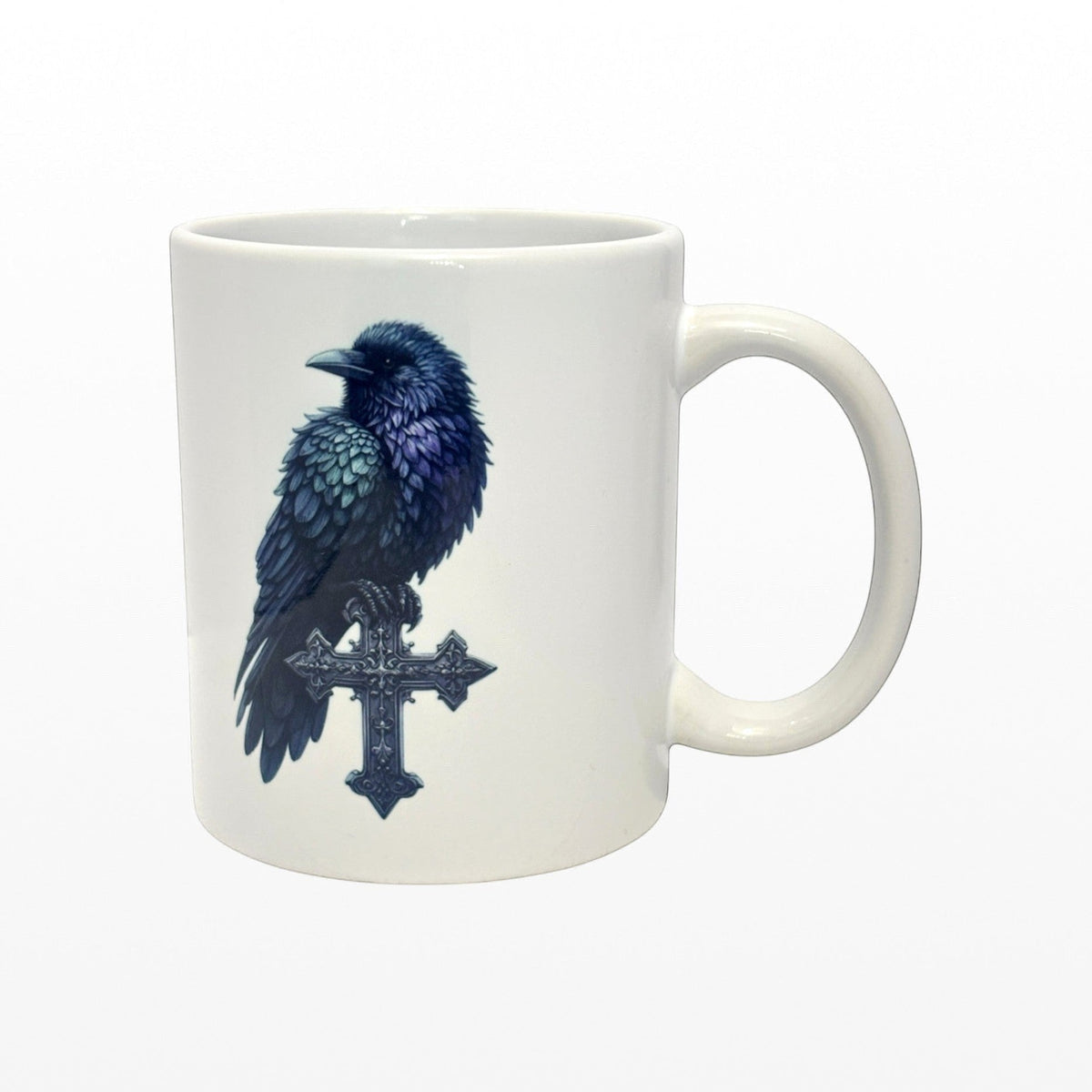Illustrated Solutions Store white ceramic mug with a detailed black raven perched on a gothic cross.
