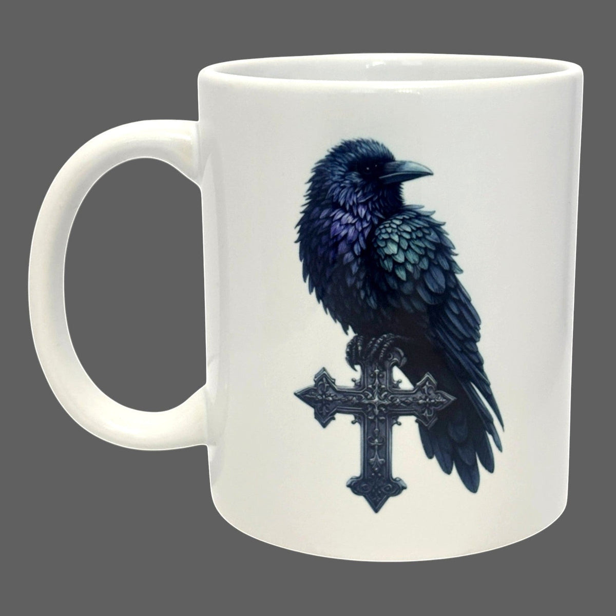 Illustrated Solutions Store white ceramic mug with a detailed black raven perched on a gothic cross.