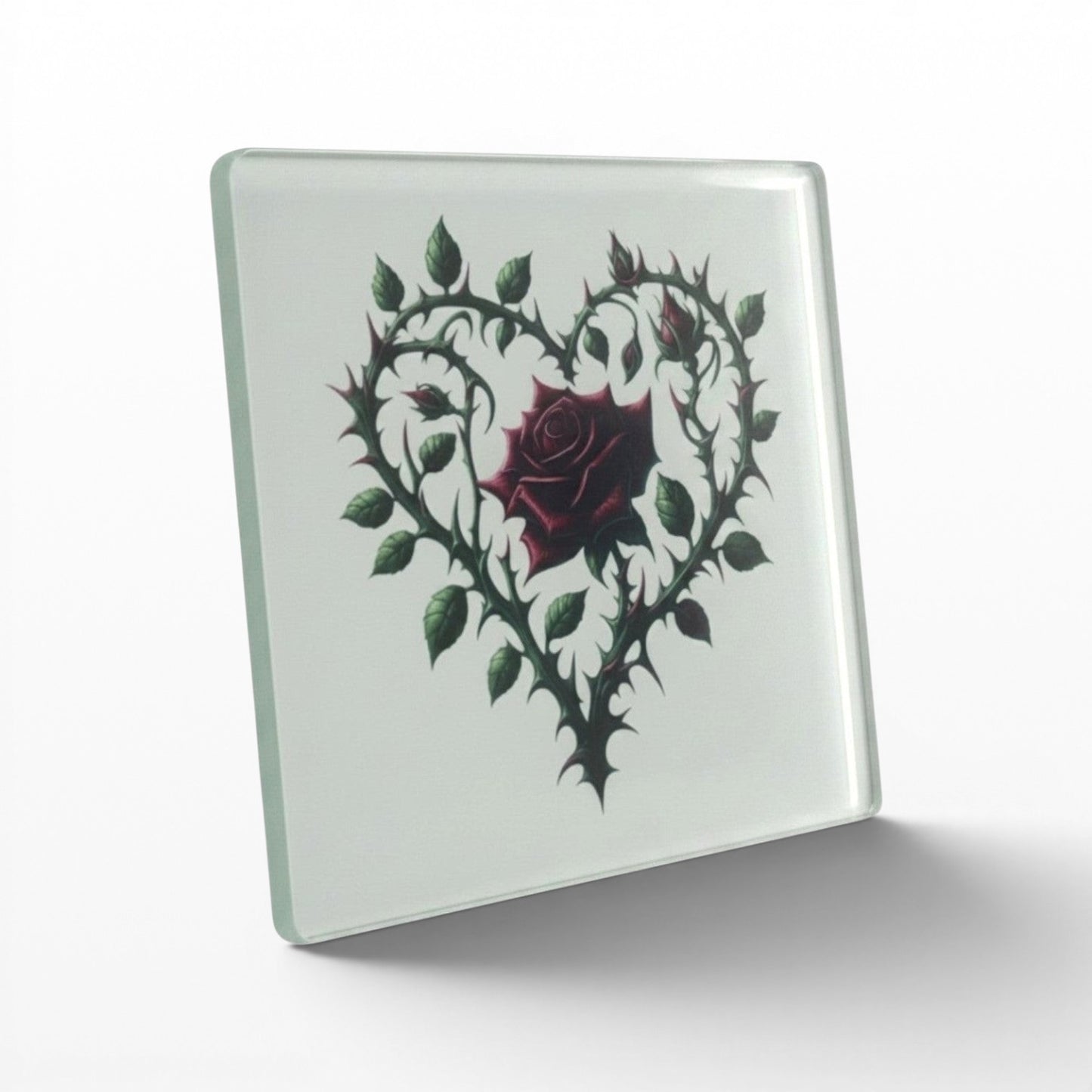 Illustrated Solutions Store gothic thorn rose heart glass coaster. Features a dark red rose surrounded by thorny vines forming a heart shape.
