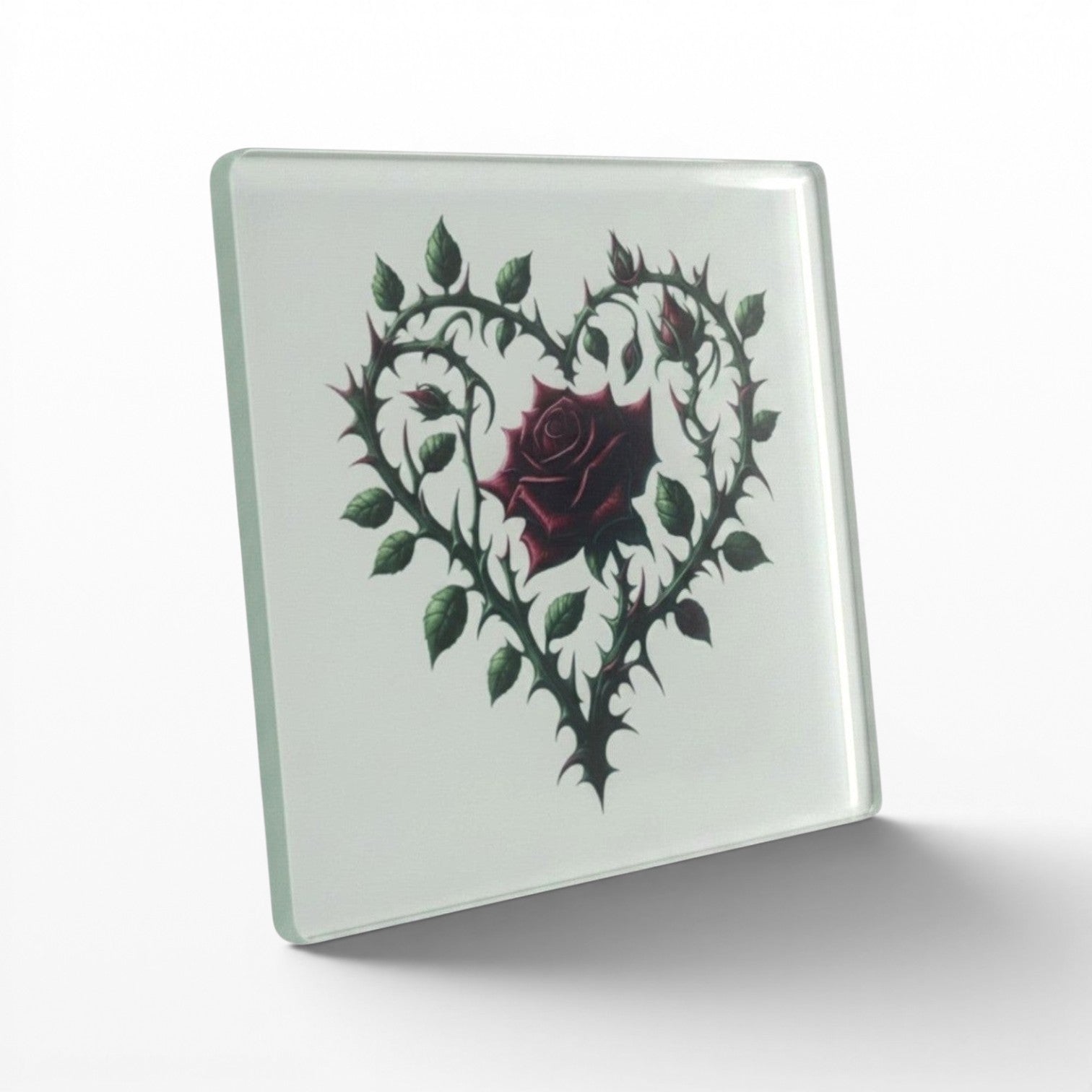 Illustrated Solutions Store gothic thorn rose heart glass coaster. Features a dark red rose surrounded by thorny vines forming a heart shape.