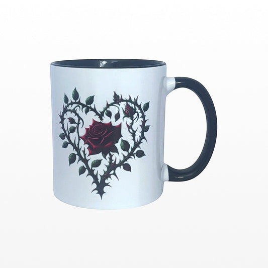 White mug with black interior and handle featuring a red rose and heart design on a white background