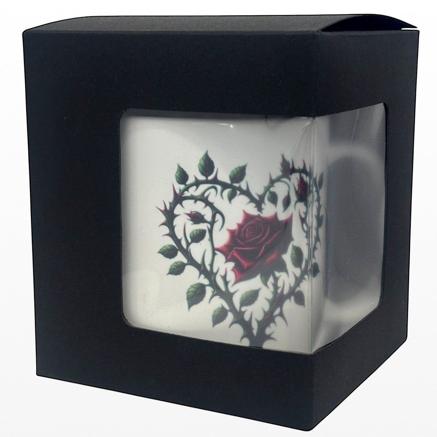 Black box with a clear front displaying a white mug with a red rose design.