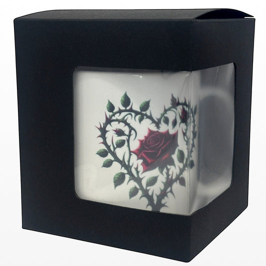 Black box with a clear front displaying a white mug with a red rose design.