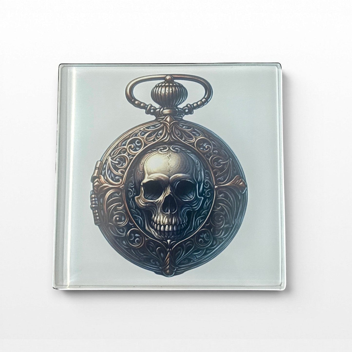 Illustrated Solutions Store gothic glass coaster with a skull in a pocket watch design. Features ornate detailing and a vintage steampunk style.