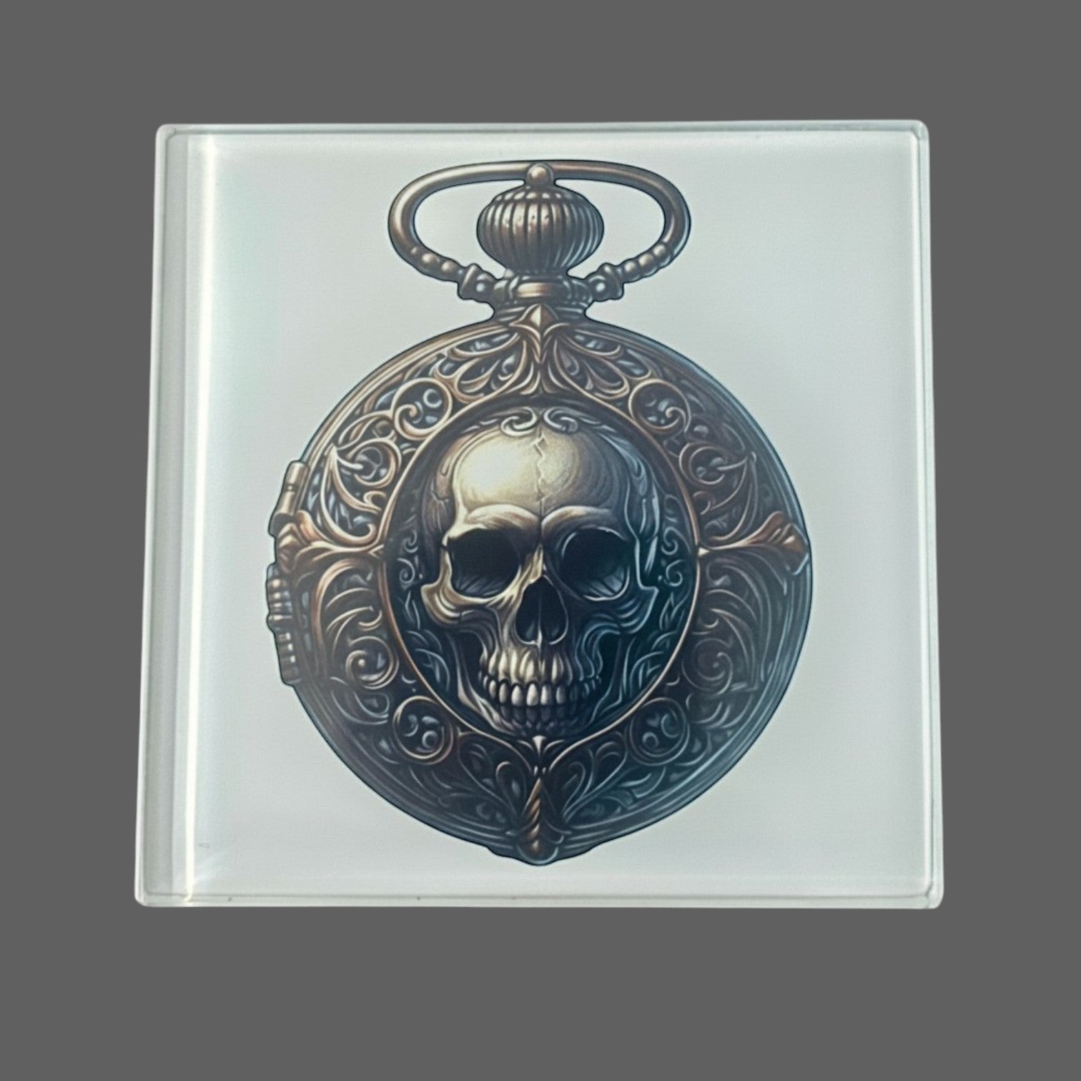Illustrated Solutions Store gothic glass coaster with skull pocket watch design. Features ornate vintage detailing.