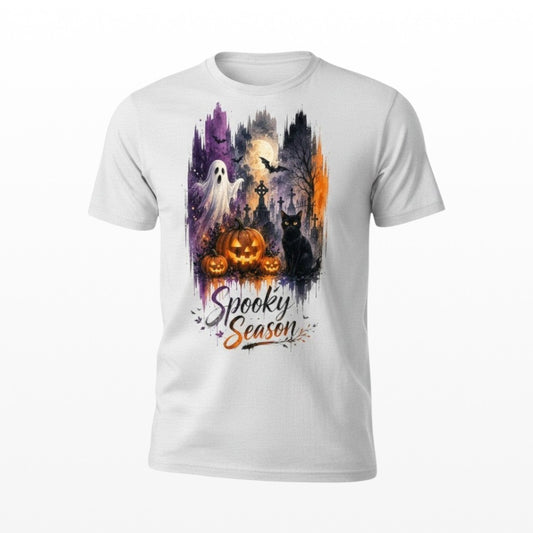 Illustrated Solutions Store white unisex T-shirt with a spooky Halloween graveyard, ghost, cat, and pumpkin graphic.