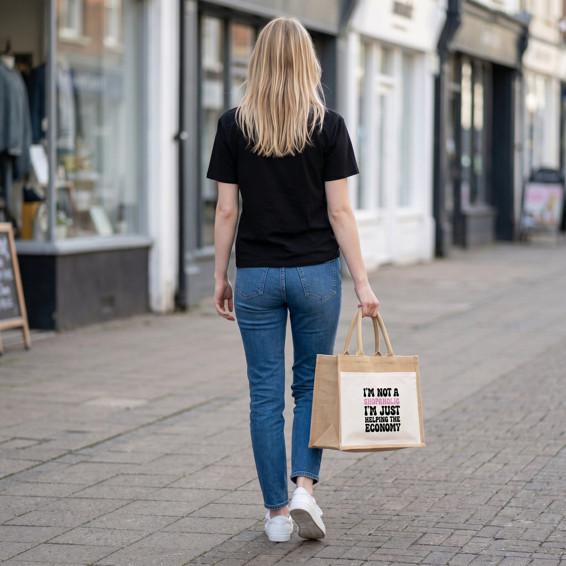 Woman walking on a street carrying an Illustrated Solutions Store jute tote bag with a sarcastic shopping quote.