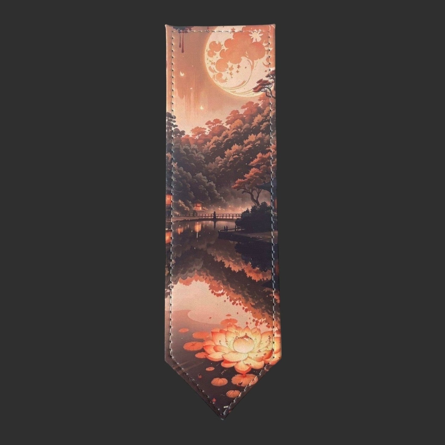 Illustrated Solutions Store leather bookmark featuring a moonlit forest reflection with autumn trees and a lotus flower.