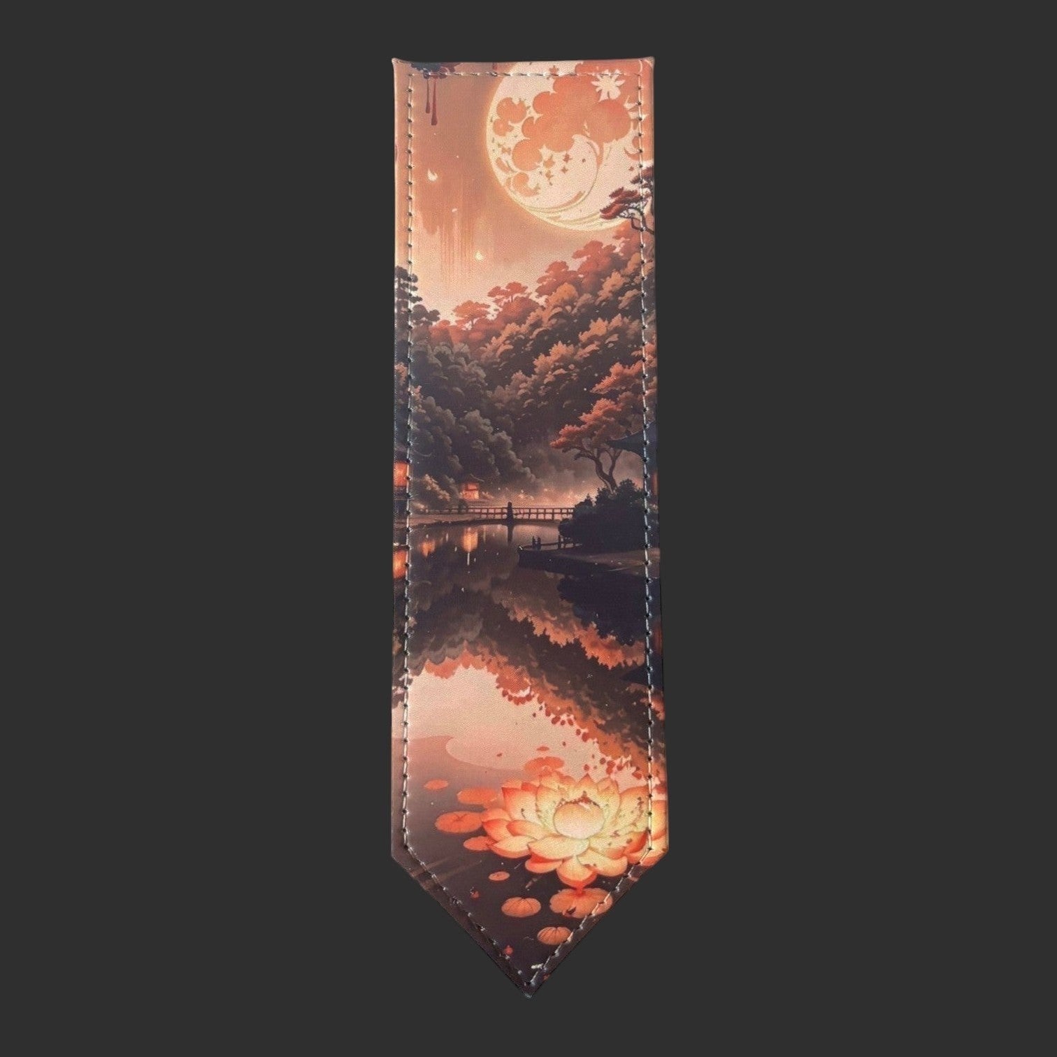 Illustrated Solutions Store leather bookmark featuring a moonlit forest reflection with autumn trees and a lotus flower.