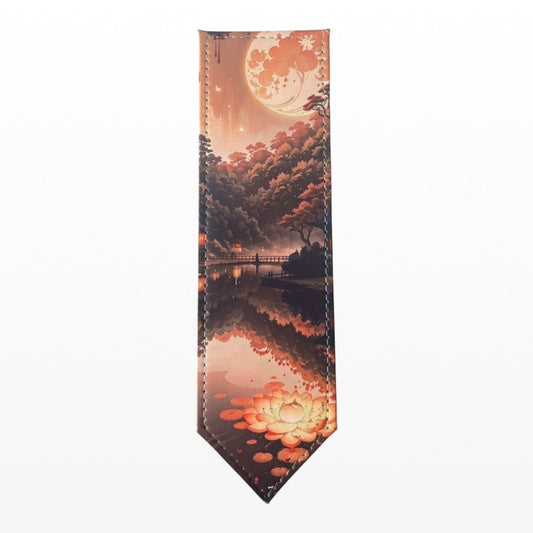 Illustrated Solutions Store leather bookmark featuring a mountain sunrise reflection in water with lotus flowers. Orange and pink hues.