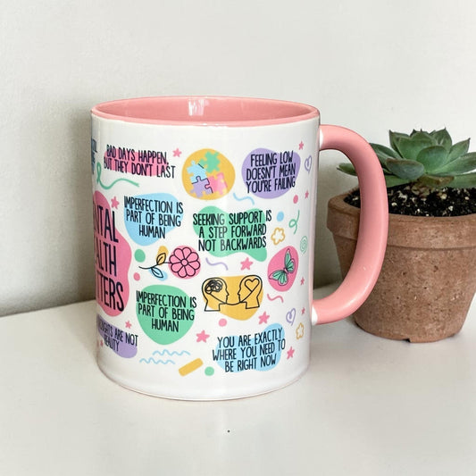 Illustrated Solutions Store mental health matters mug with pink handle and interior, featuring uplifting messages and colourful illustrations.