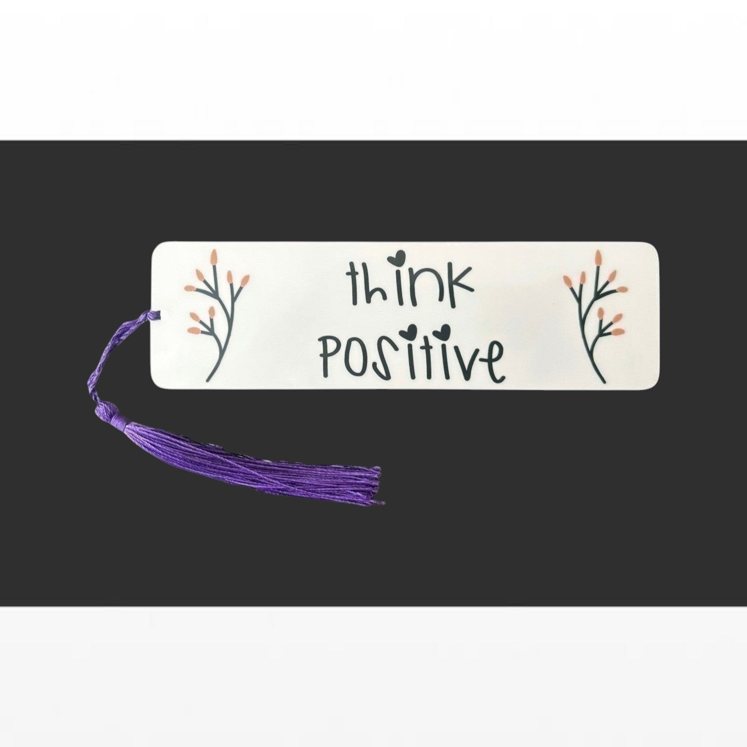 Illustrated Solutions Store metal bookmark with Think Positive text and floral accents and a purple tassel.