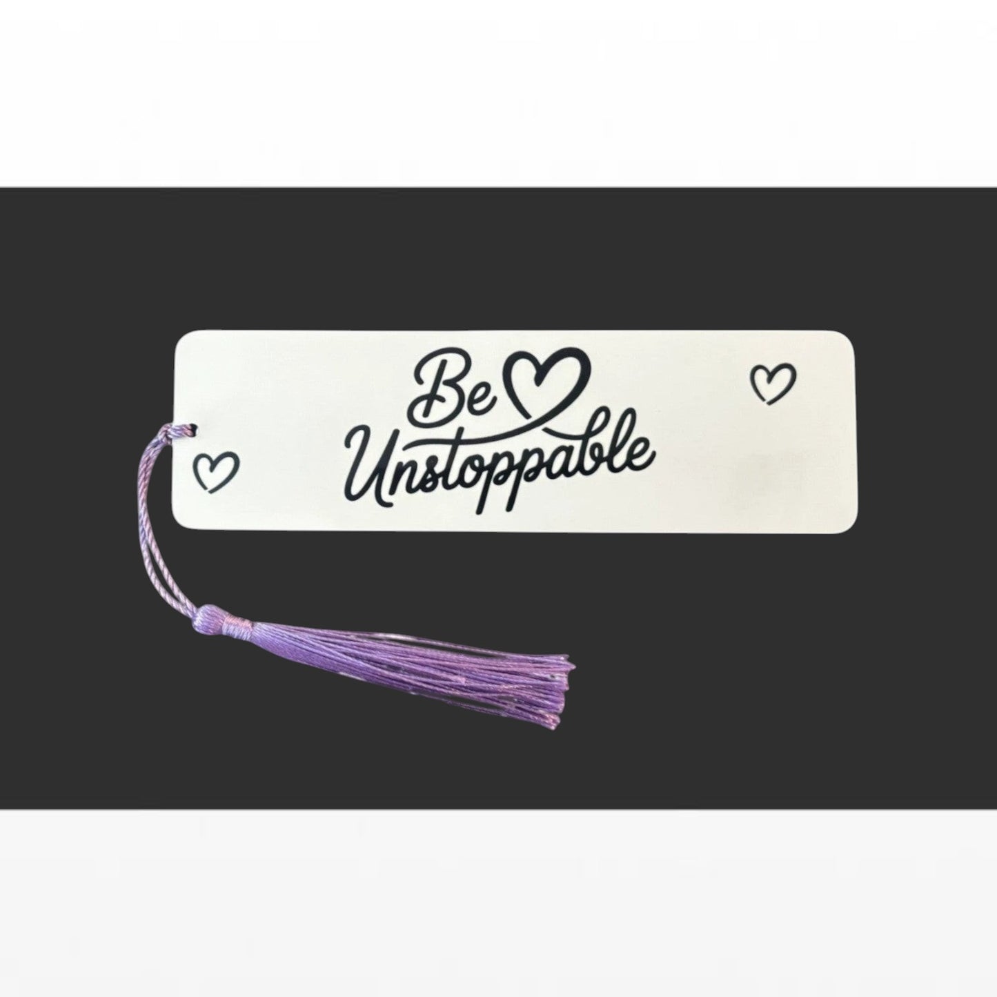 Illustrated Solutions Store white aluminium bookmark with Be Unstoppable script text and purple tassel