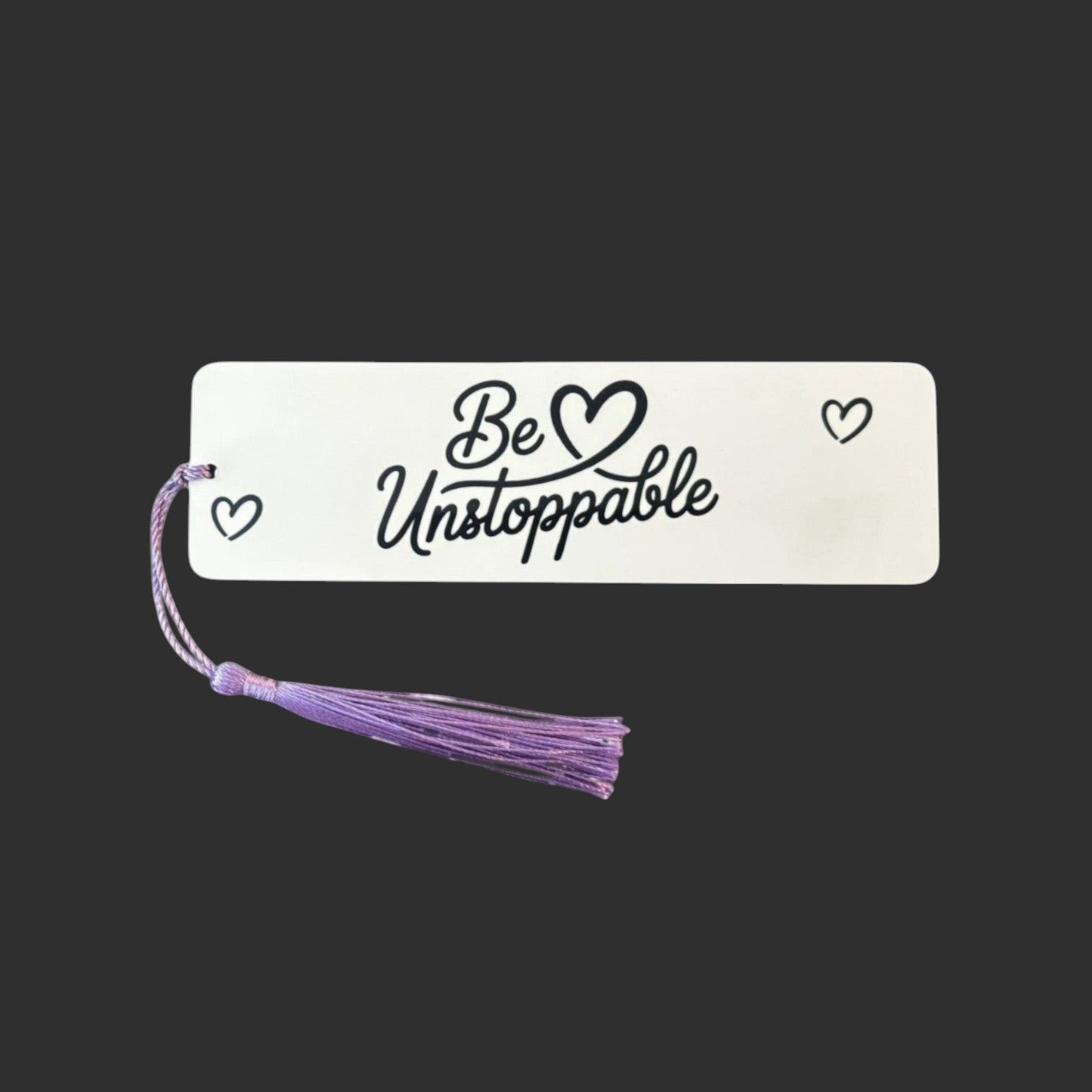 Illustrated Solutions Store white aluminium bookmark with Be Unstoppable script text and purple tassel