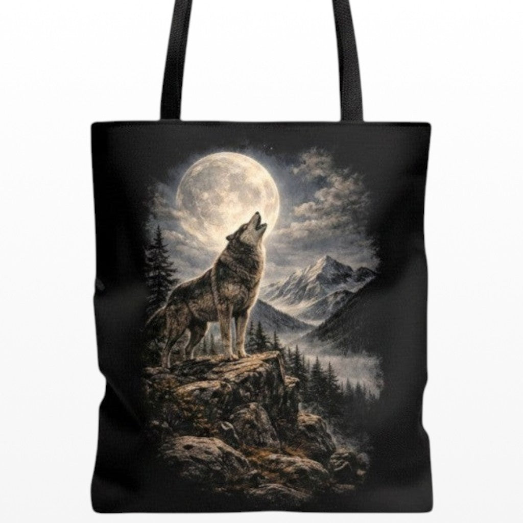 Illustrated Solutions Store black canvas tote bag featuring a majestic wolf howling at a full moon in a mountain scene.