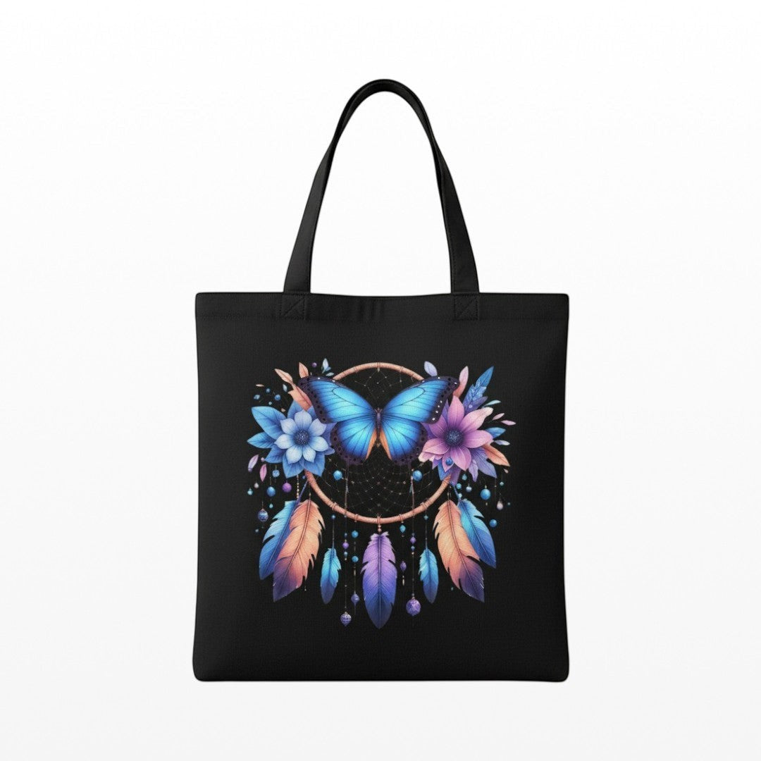 Illustrated Solutions Store spiritual canvas tote bag featuring a blue butterfly, dreamcatcher, flowers, and feathers.