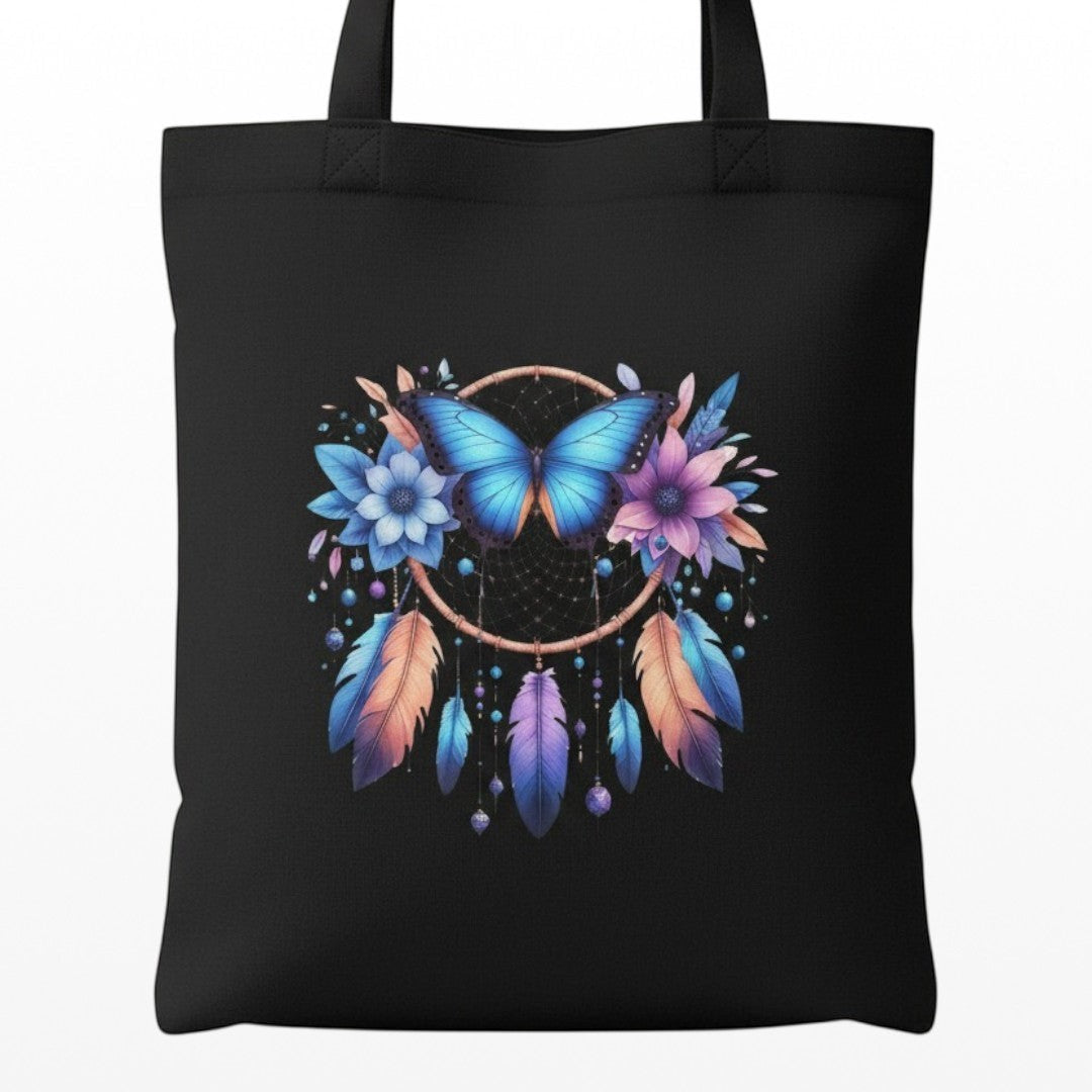 Illustrated Solutions Store spiritual canvas tote bag featuring a blue butterfly, dreamcatcher, flowers, and feathers. Close up view