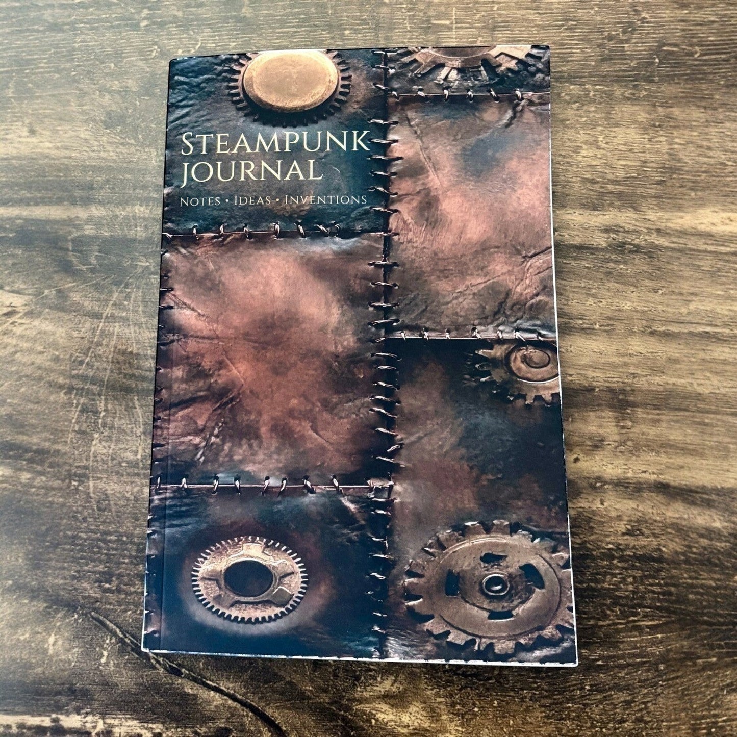 Illustrated Solutions Store Steampunk Journal with vintage leather design, gears, and stitched details. Ideal for notes, ideas, and inventions.