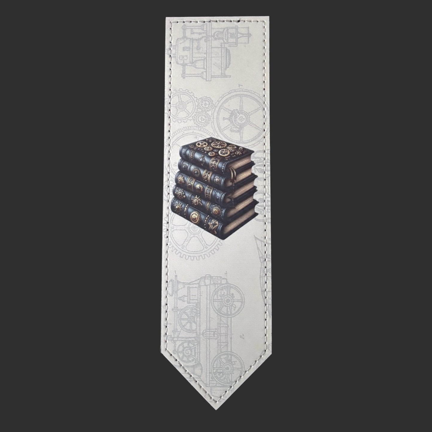 Illustrated Solutions Store steampunk leather bookmark featuring a stack of vintage books and mechanical gear patterns.