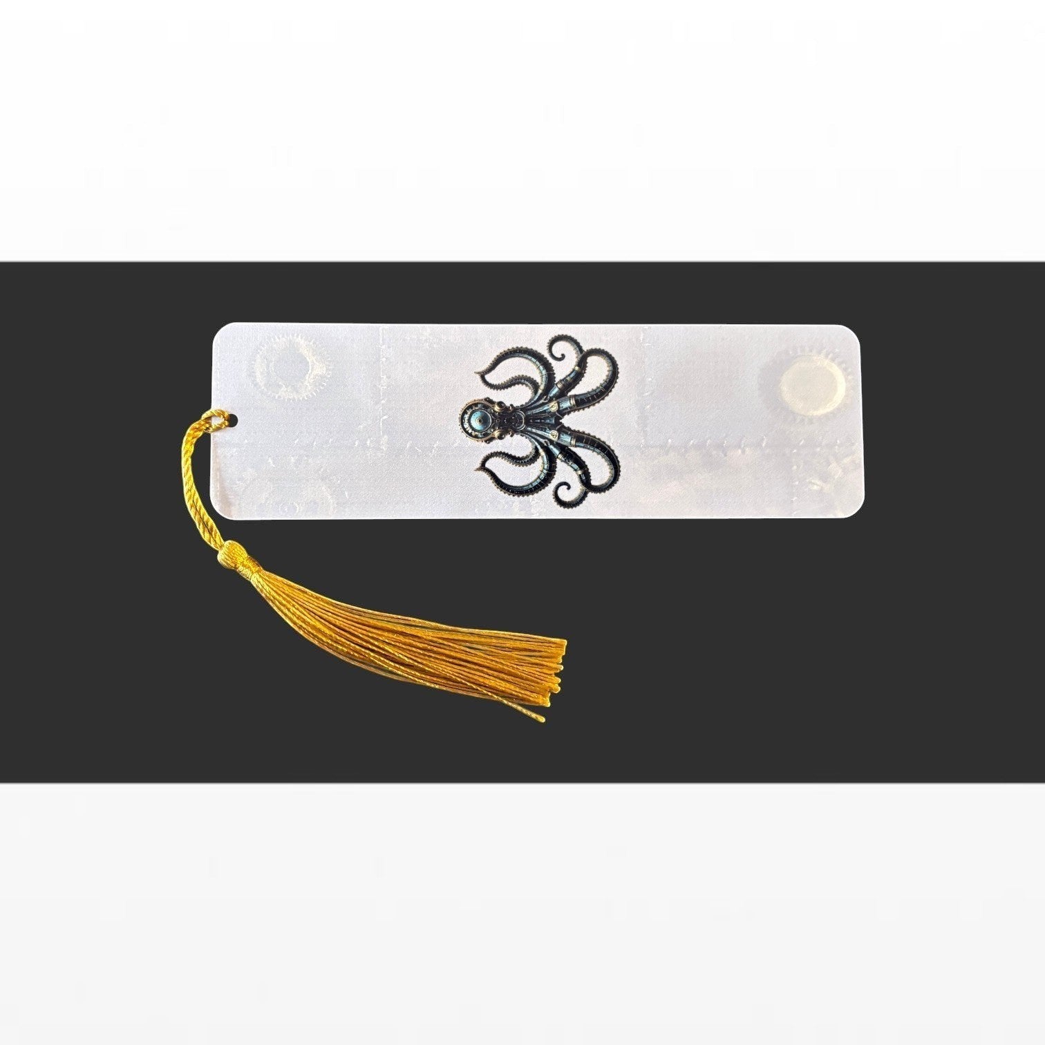Illustrated Solutions Store steampunk octopus aluminium bookmark with a vibrant gold tassel on a black background.
