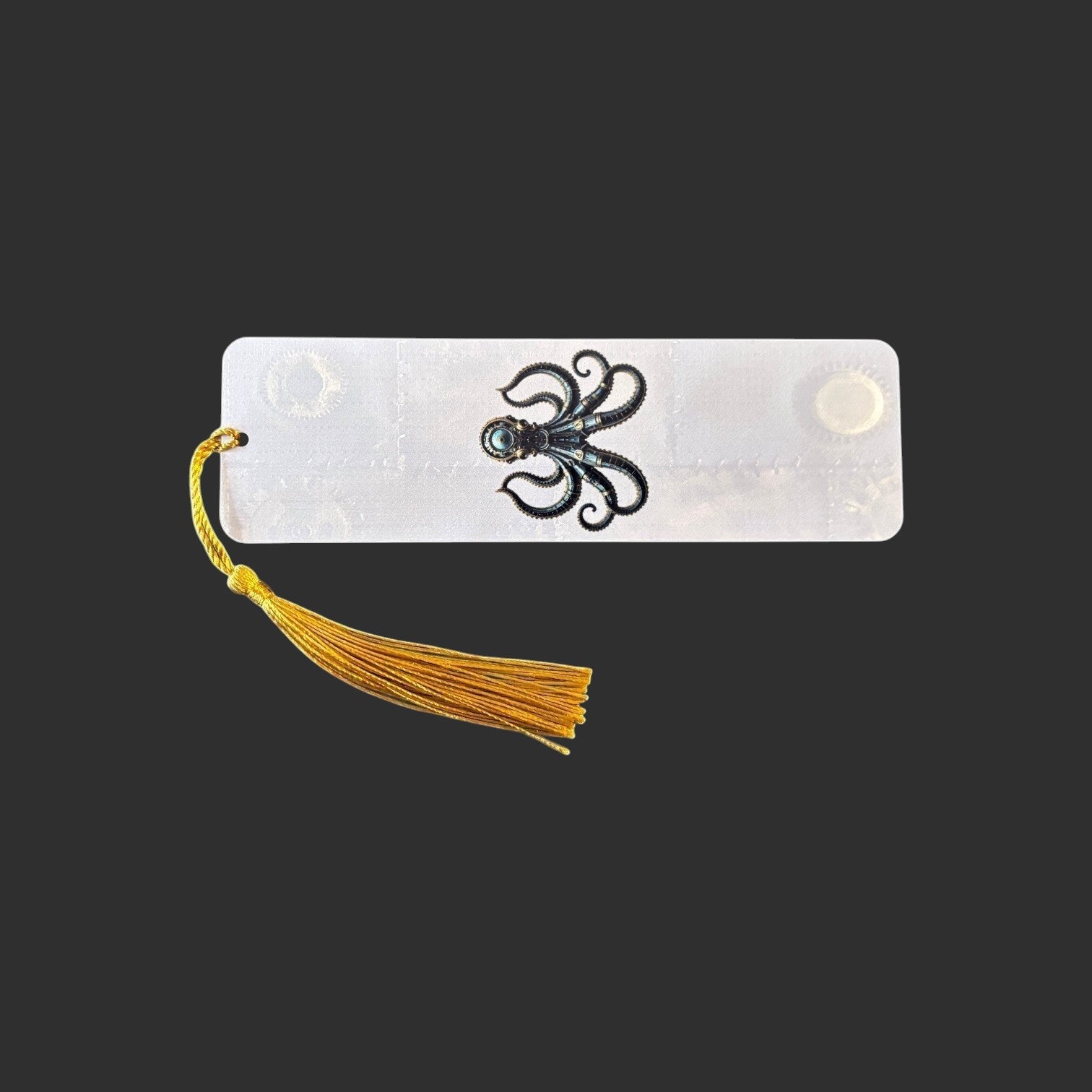 Illustrated Solutions Store steampunk octopus aluminium bookmark with a vibrant gold tassel on a black background.