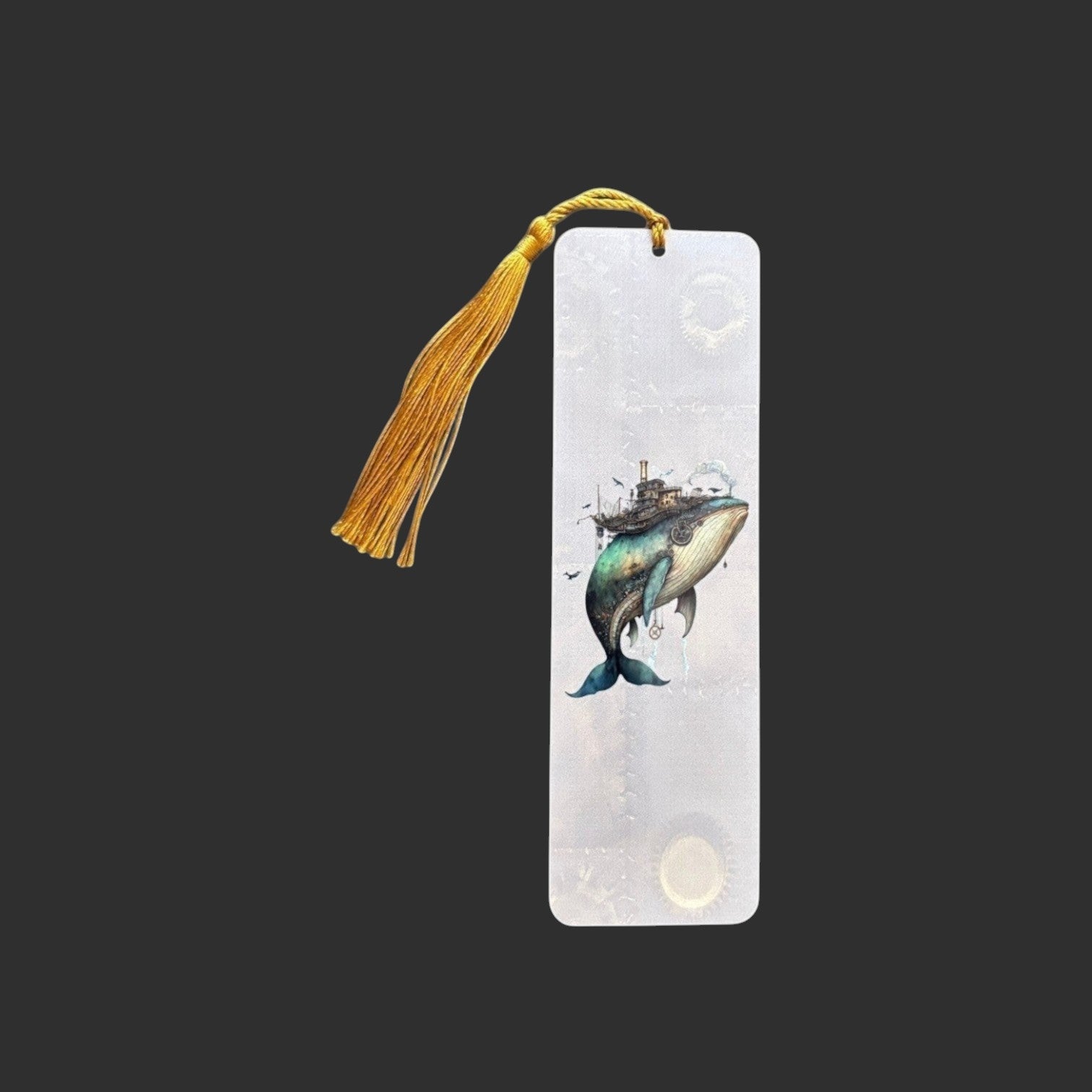 Illustrated Solutions Store steampunk whale bookmark made of durable aluminium with a vibrant gold tassel. Vertical view.