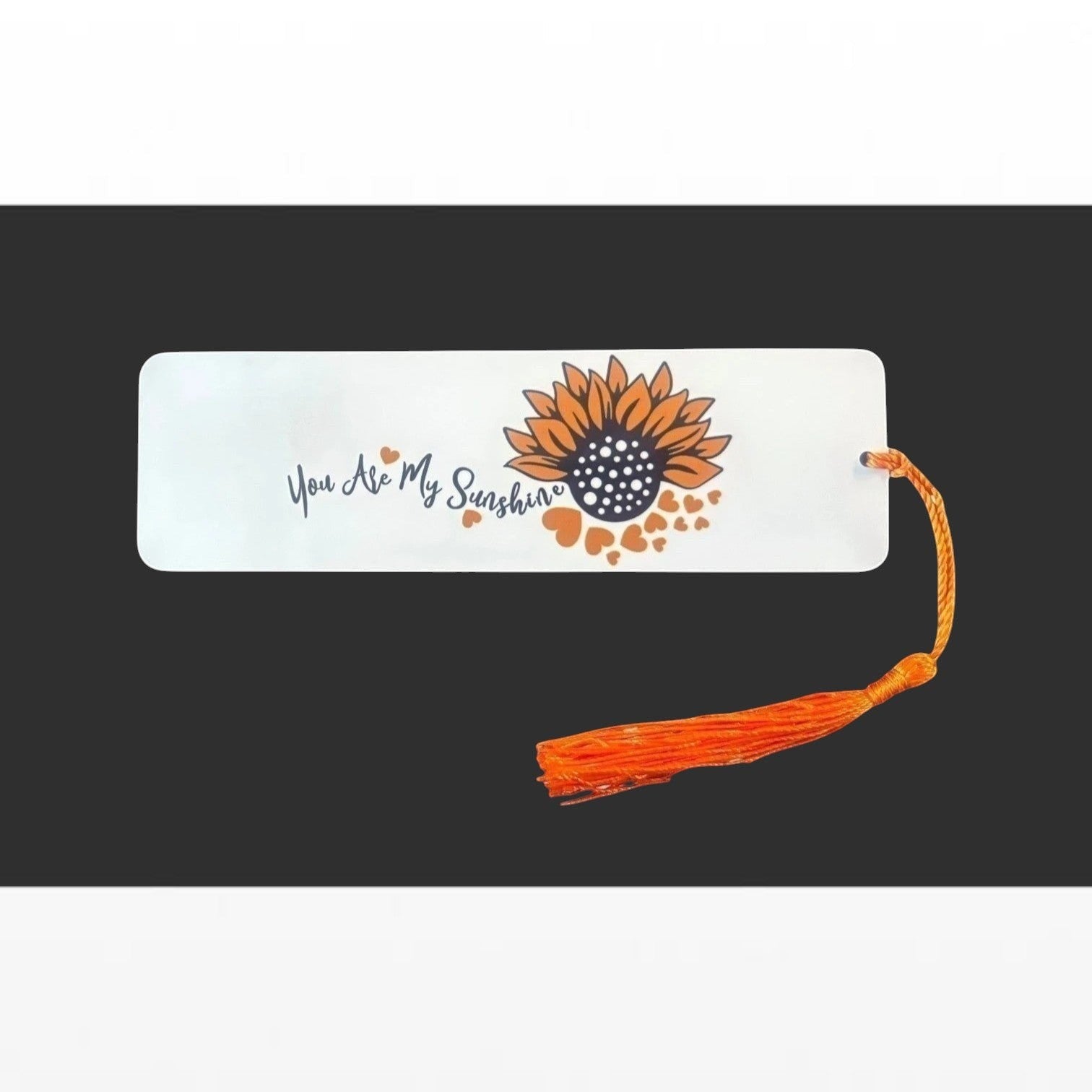 Illustrated Solutions Store metal bookmark with You Are My Sunshine text and a sunflower design with an orange tassel.