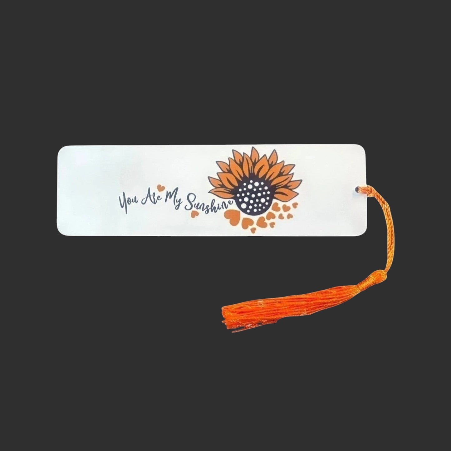 Illustrated Solutions Store metal bookmark with You Are My Sunshine text and a sunflower design with an orange tassel.