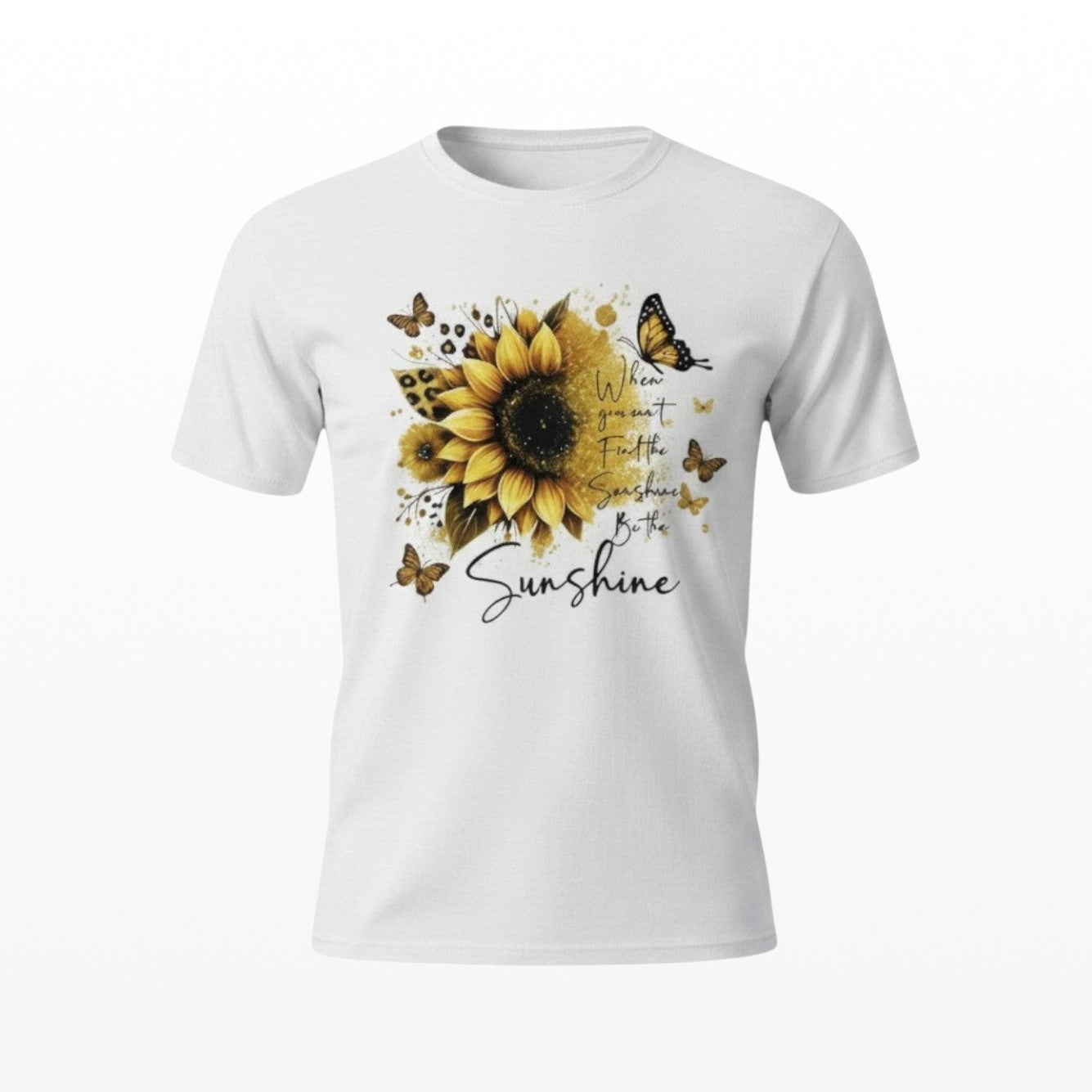 Illustrated Solutions Store white t-shirt featuring a sunflower, butterflies, and Be The Sunshine affirmation text.