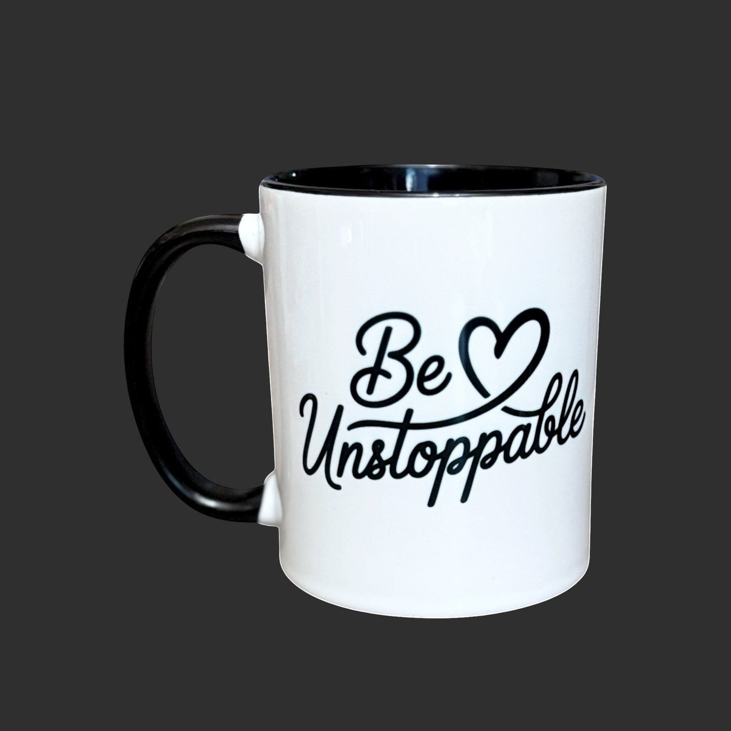 Illustrated Solutions Store white ceramic mug with black handle and rim, featuring the text "Be Unstoppable" in black script.