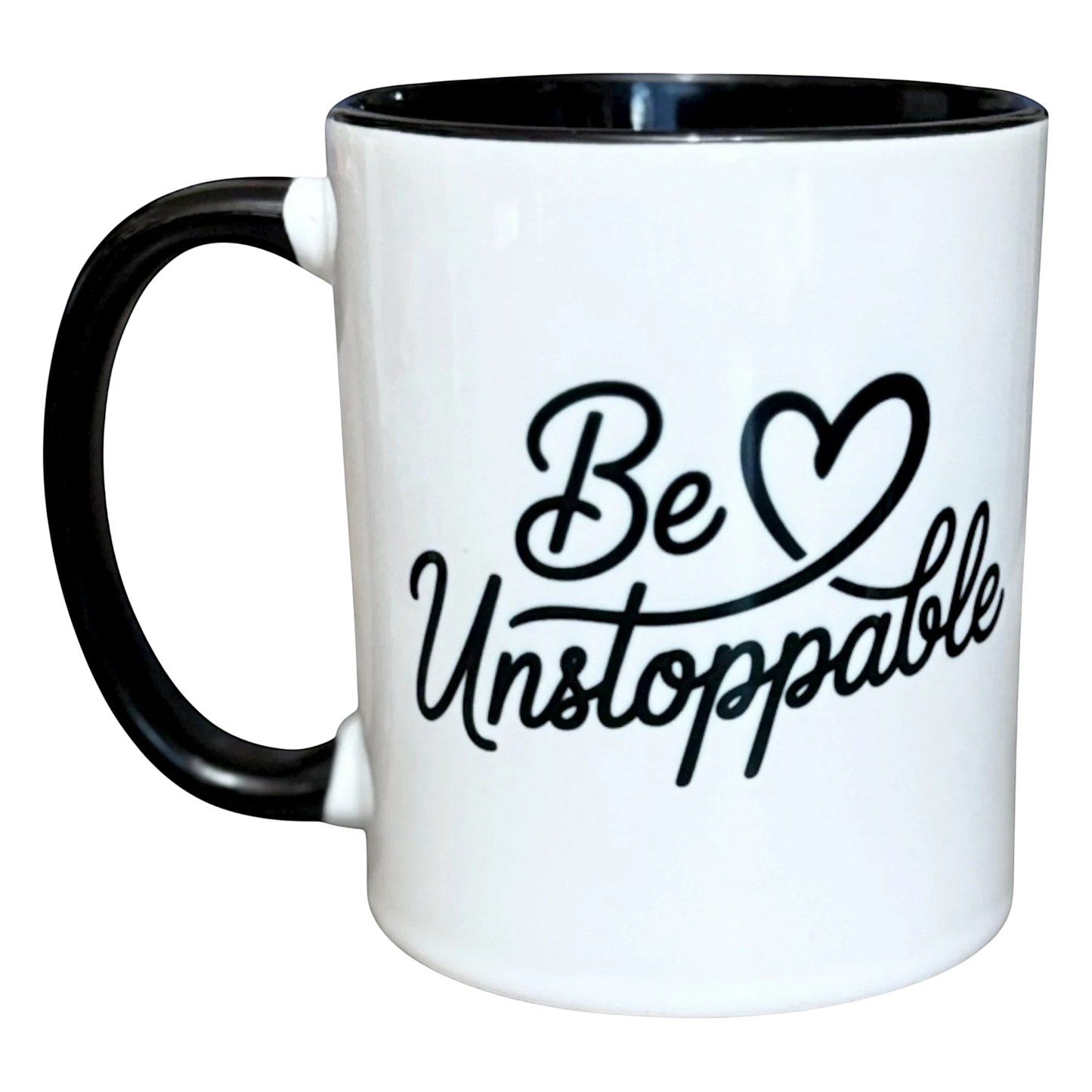 Illustrated Solutions Store white ceramic mug with black handle and rim, featuring the text "Be Unstoppable" in black script.