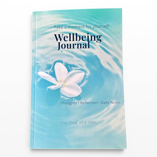 Illustrated Solutions Store Wellbeing Journal with a white flower floating on rippling blue water. For thoughts, reflection, and daily notes.