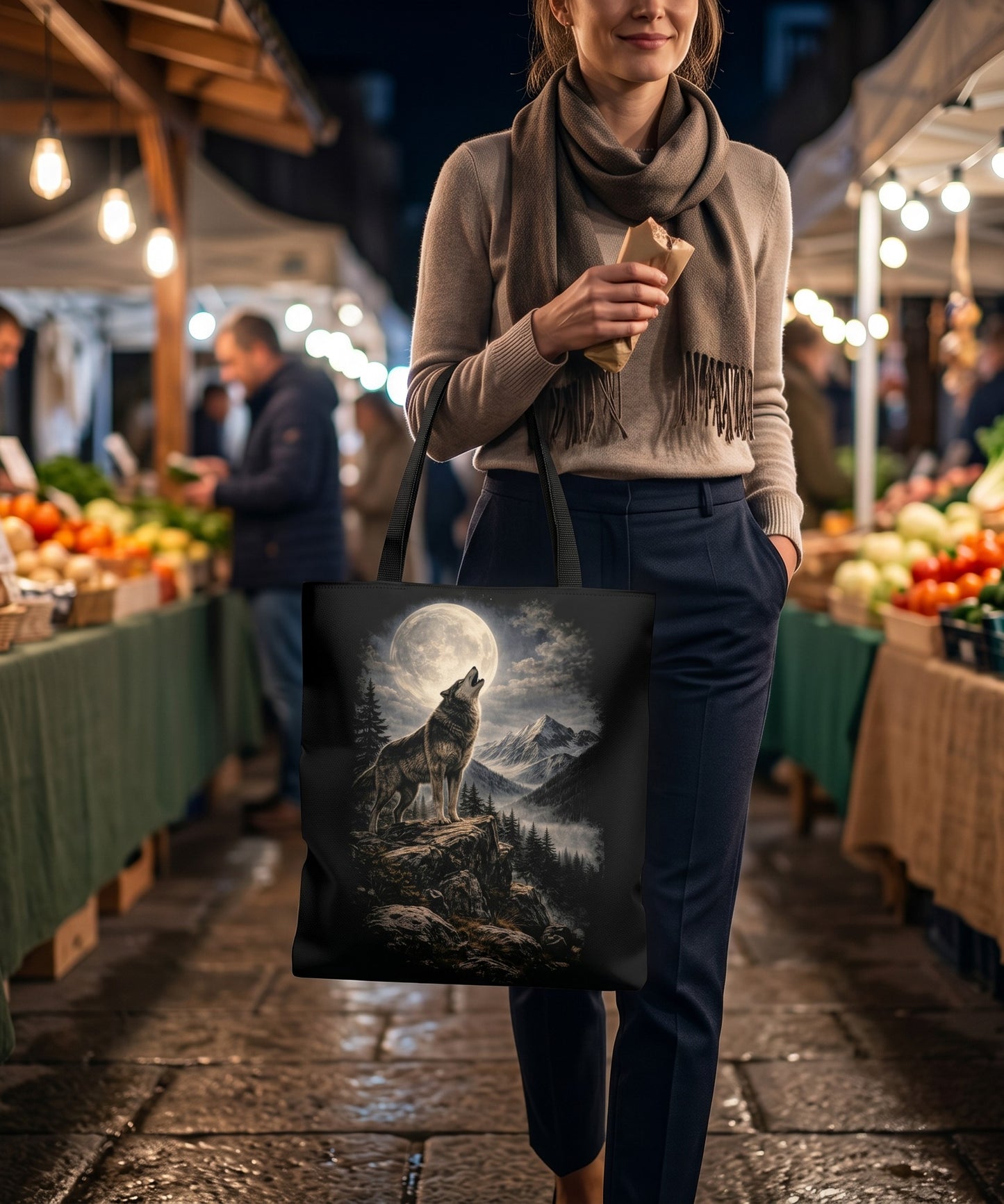 Illustrated Solutions Store canvas tote bag featuring a wolf howling at the moon, carried by a woman at a market.