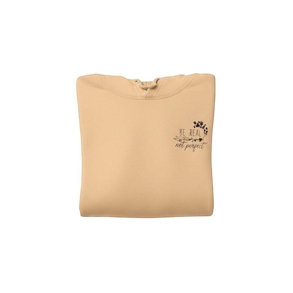Illustrated Solutions Store folded view of beige cotton hoodie with 'Be Real Not Perfect' floral butterfly print.