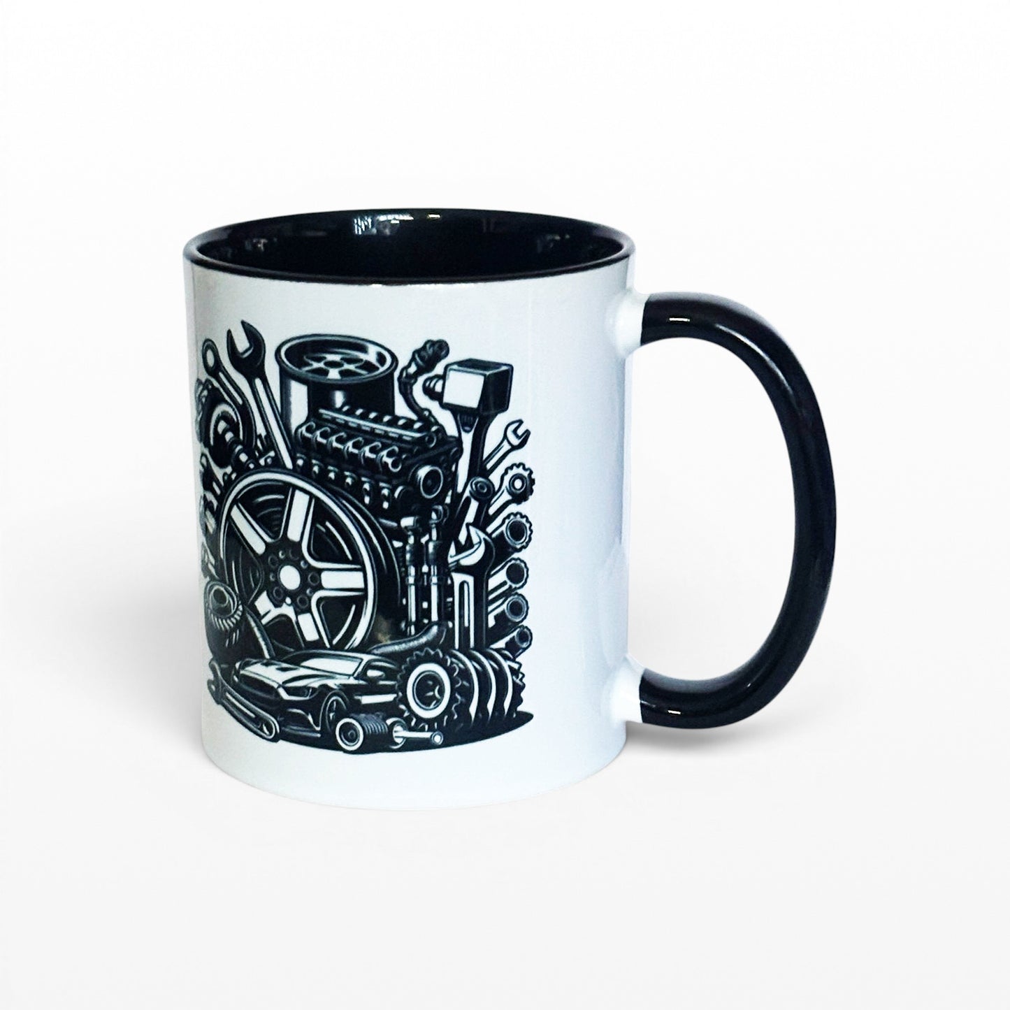 Illustrated Solutions Store white ceramic mug with black interior and handle, featuring a detailed black graphic of car engine parts, tools, and a sports car.