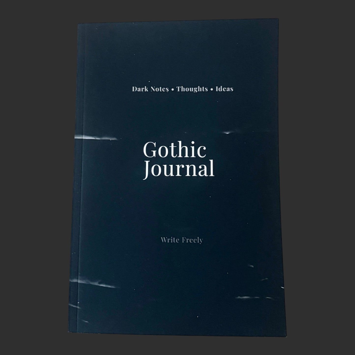 Illustrated Solutions Store Gothic Journal with 'Dark Notes Thoughts Ideas' and 'Write Freely' text on a dark cover.