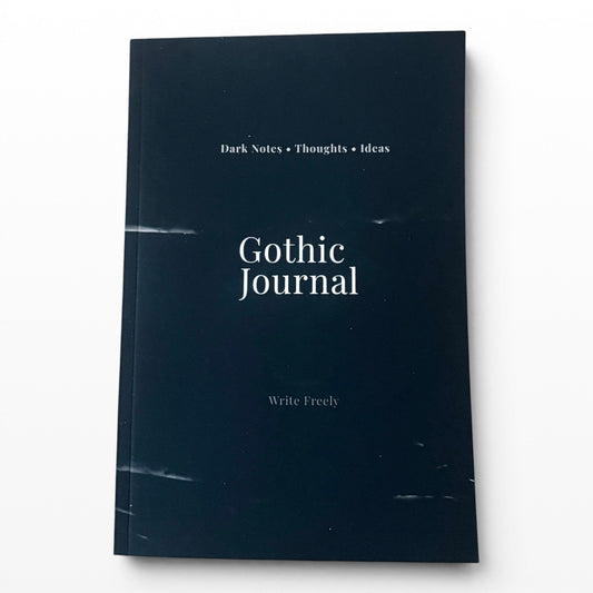 Illustrated Solutions Store Gothic Journal with 'Dark Notes • Thoughts • Ideas' and 'Write Freely' text on a dark navy cover.