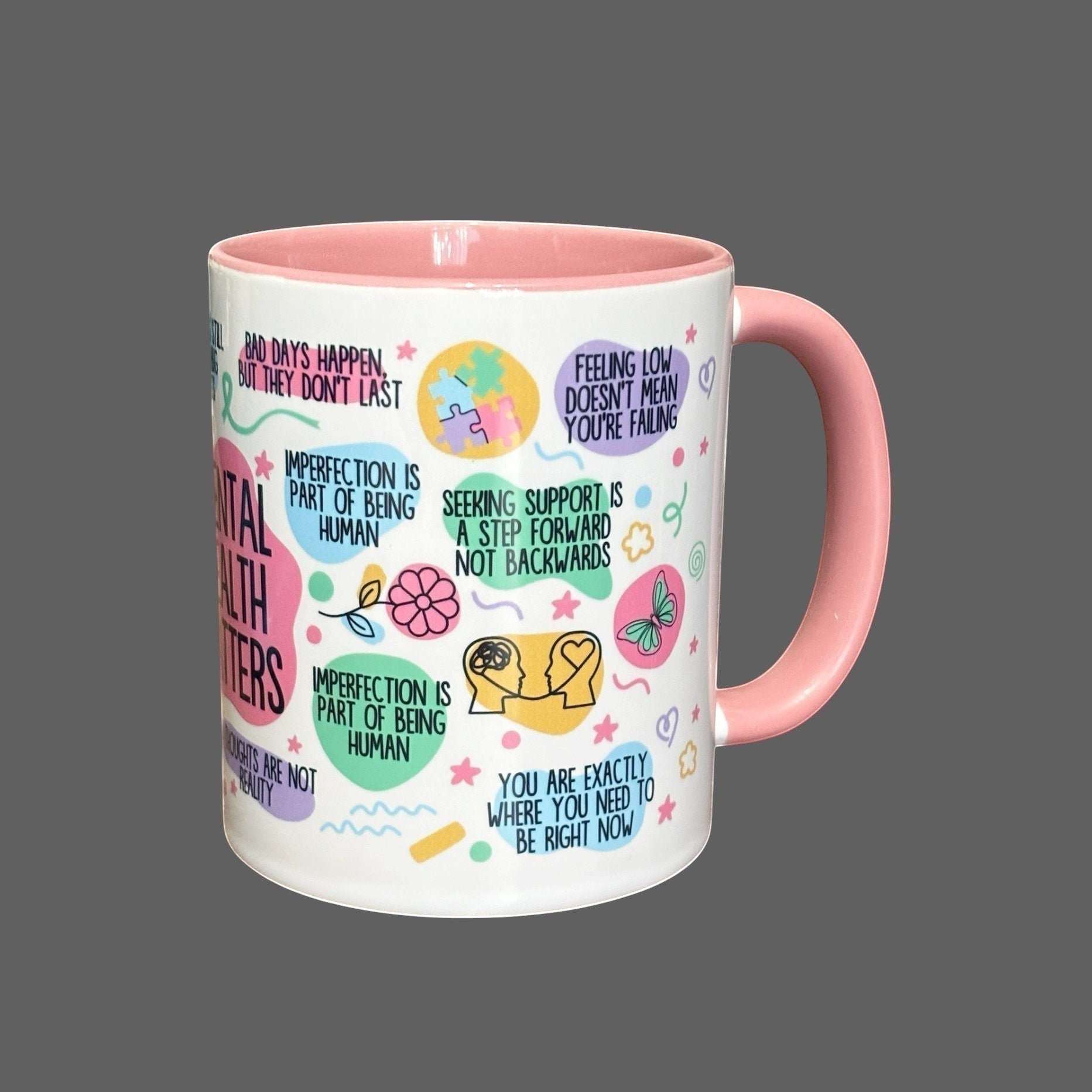 Illustrated Solutions Store white ceramic mug with pink handle and interior, featuring mental health awareness designs and uplifting messages.