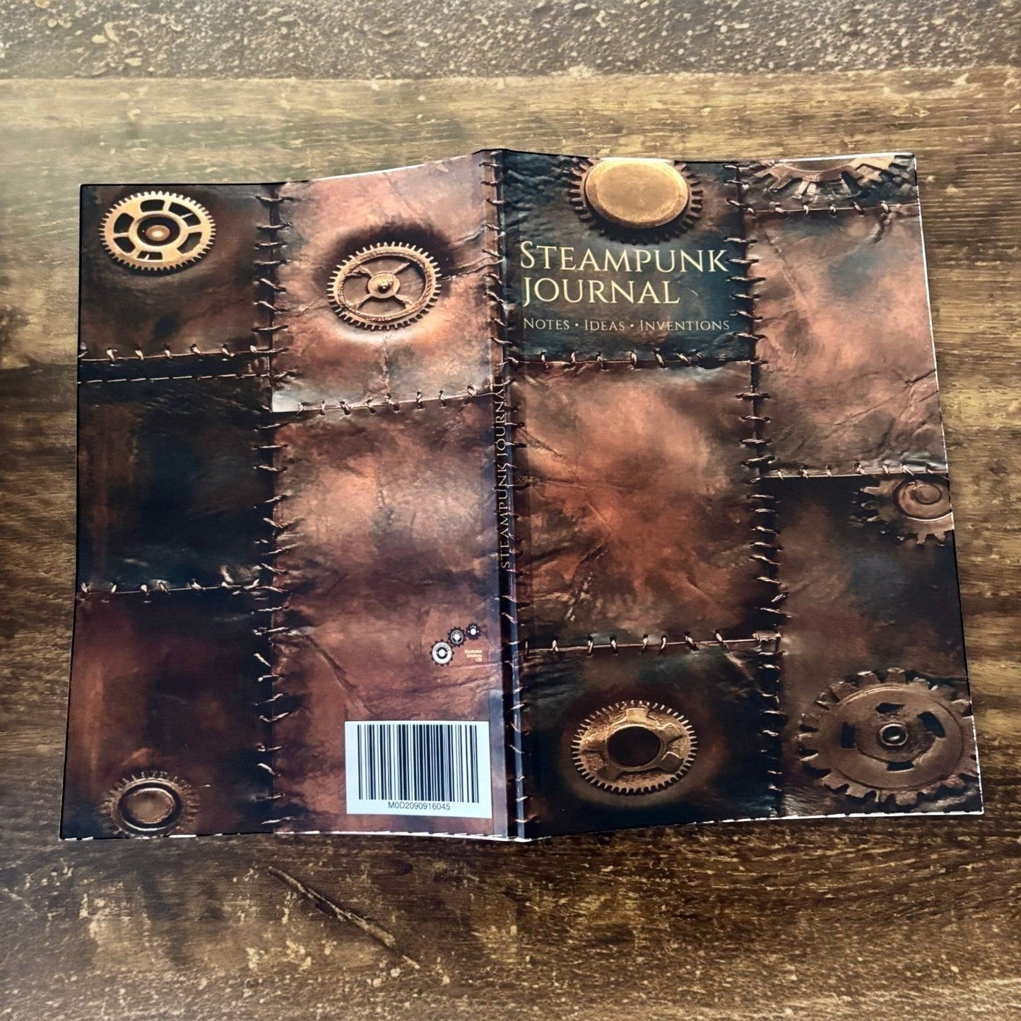 Illustrated Solutions Store steampunk journal with vintage leather design, gears, and stitched details. Ideal for notes, ideas, and inventions.
