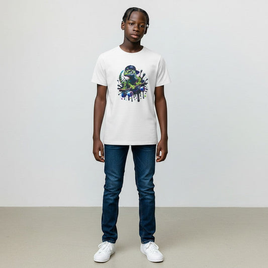 White kids t-shirt with a green gecko wearing a black baseball cap riding a skateboard with colourful paint splatters.