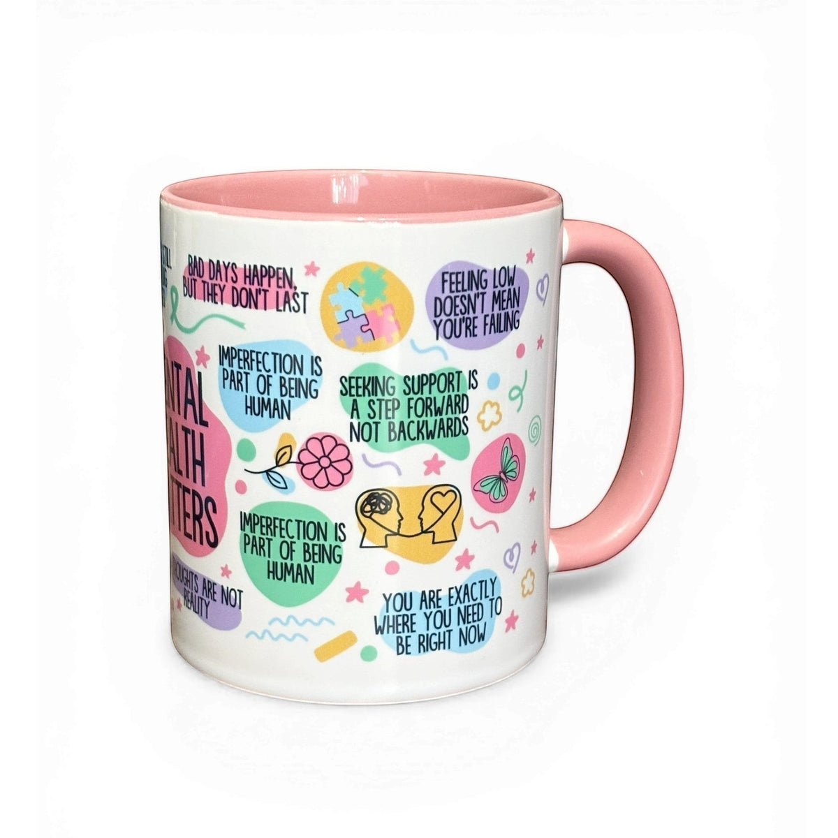 mental health mug with pink handle and interior, featuring positive affirmations and colourful graphics.