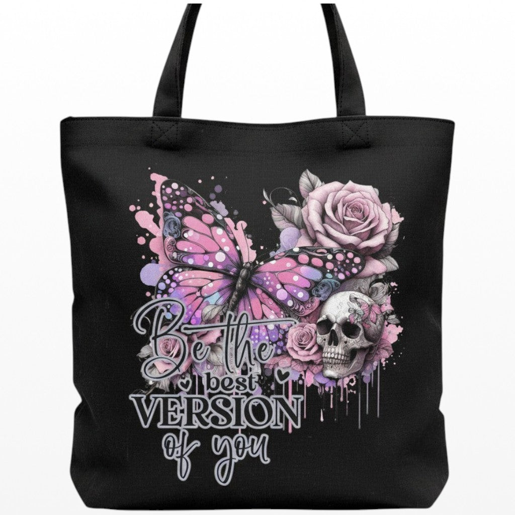 Black tote bag with a pink butterfly, roses, and skull design on a white background