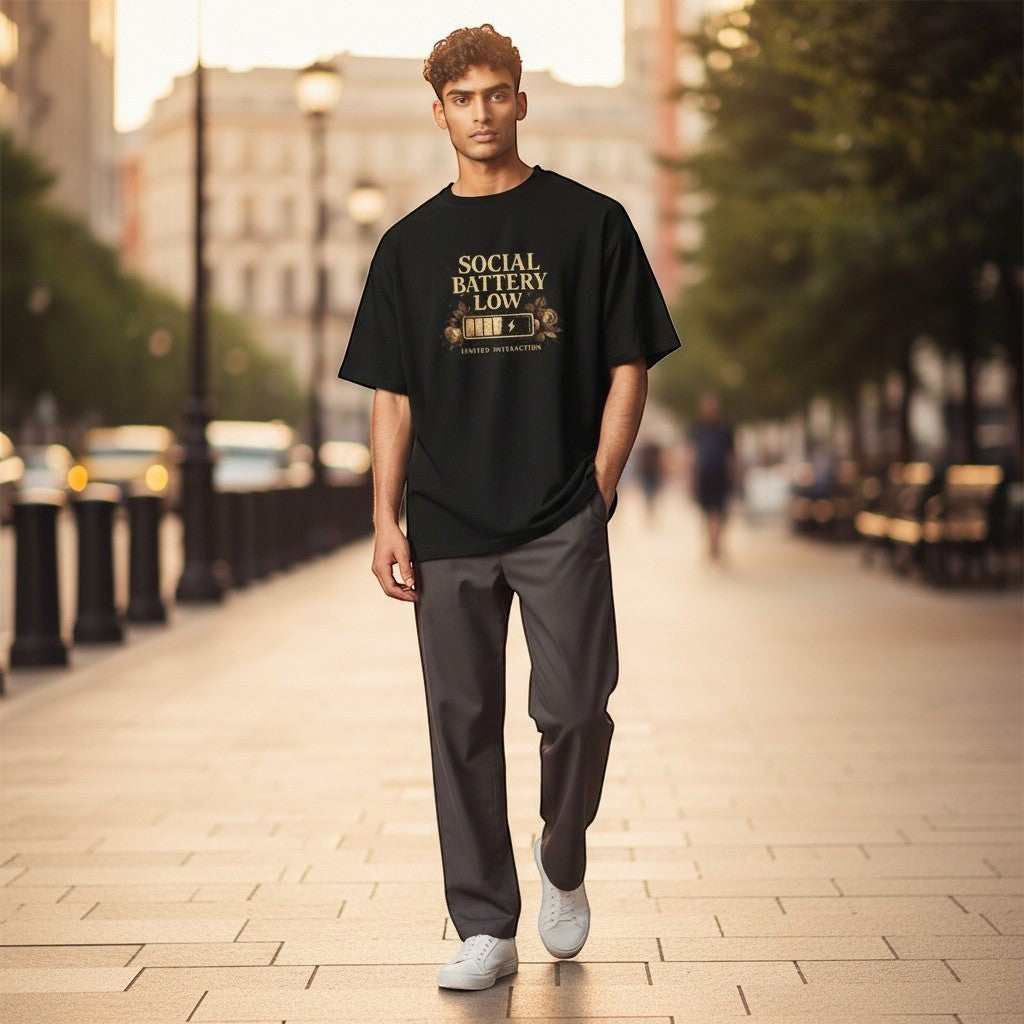 Man wearing a black t-shirt with text on a city street