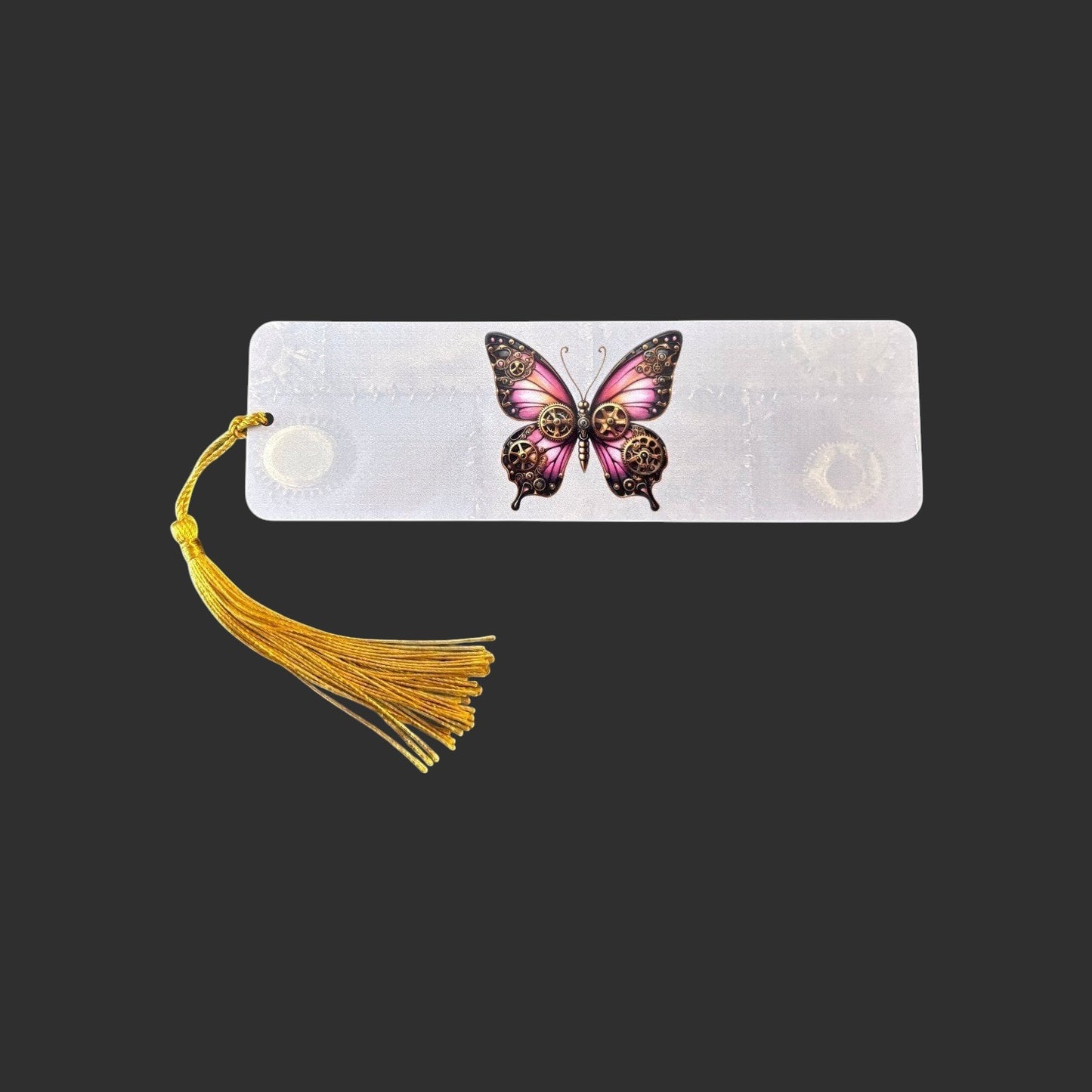 Horizontal view of an aluminium bookmark featuring an original pink steampunk butterfly illustration with bronze clockwork detailing and a gold tassel.