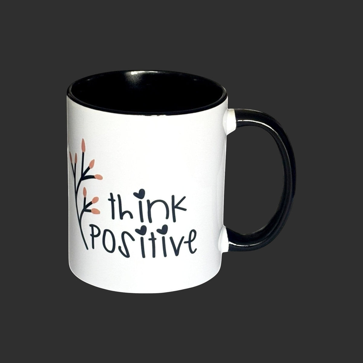 White ceramic mug with black interior and handle, featuring 'think positive' text and floral design. Right side view.