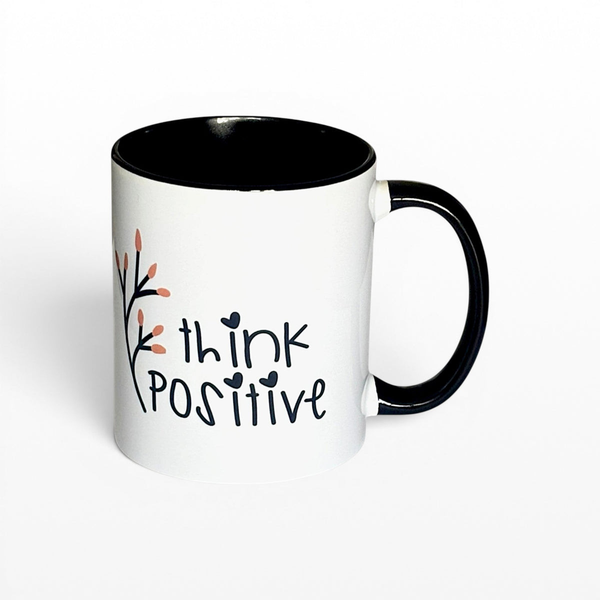 white ceramic mug with black interior and handle, featuring the text "think POSITIVE" and a delicate floral branch.