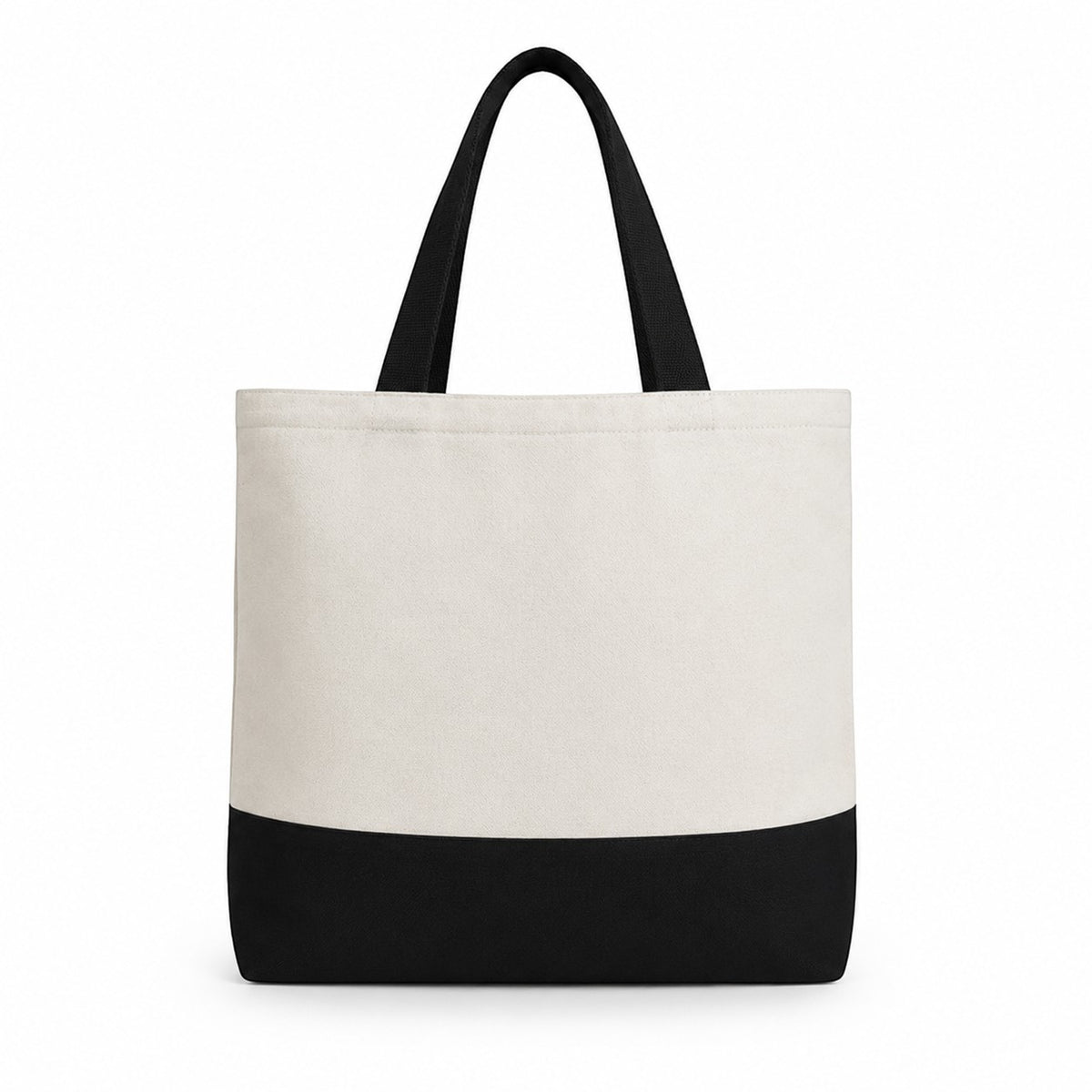 Tote bag with black bottom half and white top half on a white background