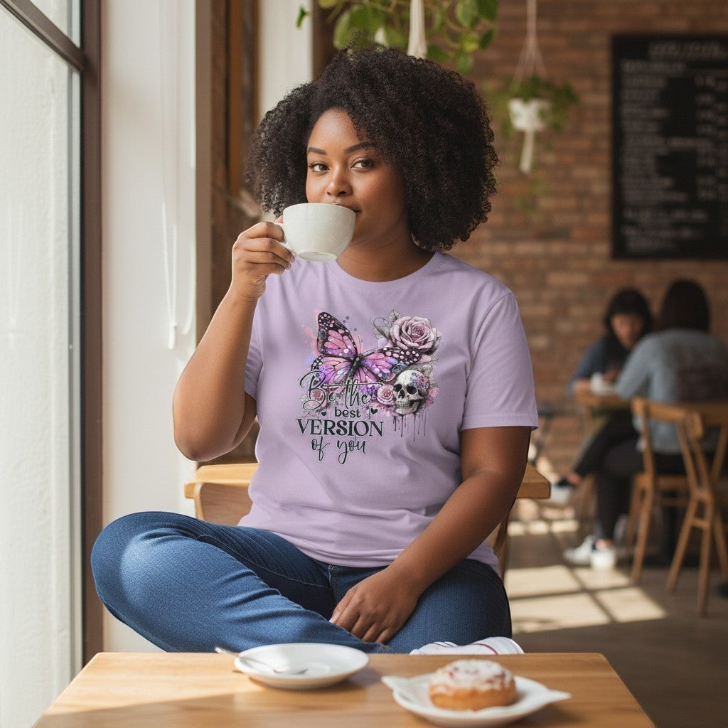 Woman sitting at a cafe, drinking coffee and wearing a gothic lilac t-shirt with a butterfly design.